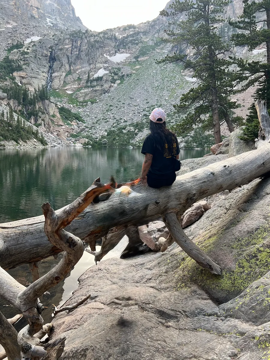 Jess relaxing beside a mountain lake in Colorado