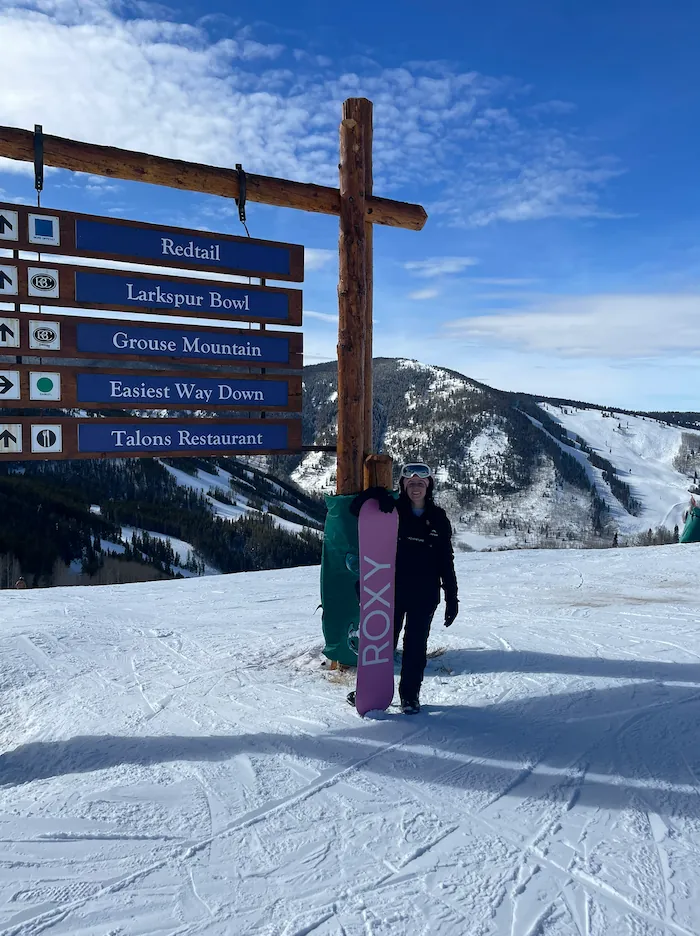 Jess snowboarding in the Colorado mountains